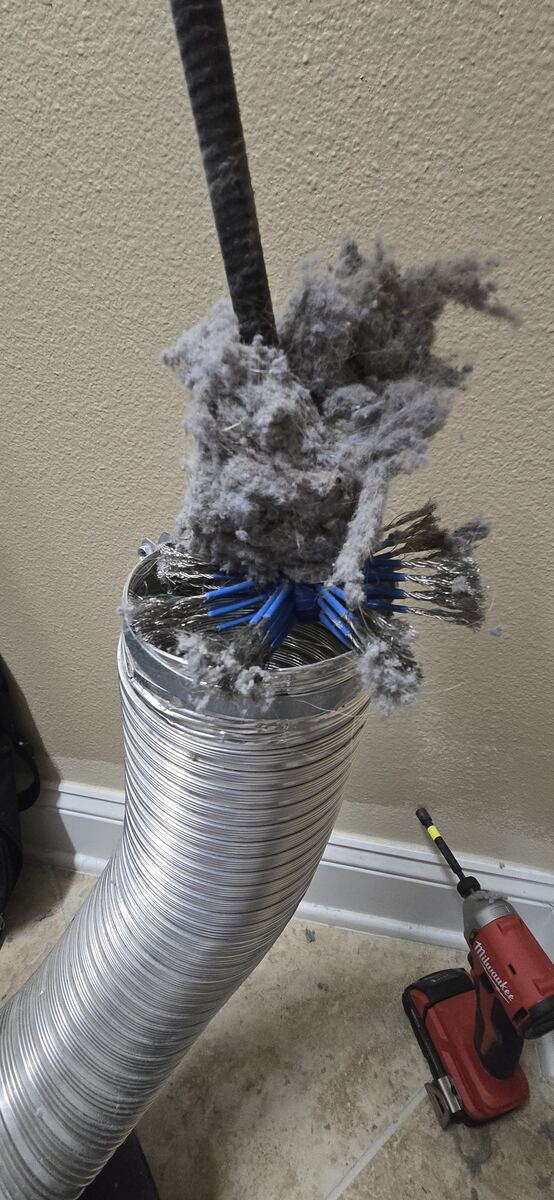 Rotary brush packed with lint pulled from a customer's dryer duct